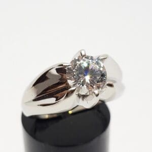 Silver ring with large round diamond.
