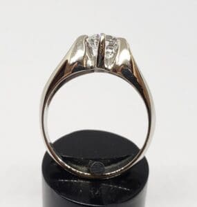 Silver ring with a central diamond setting.