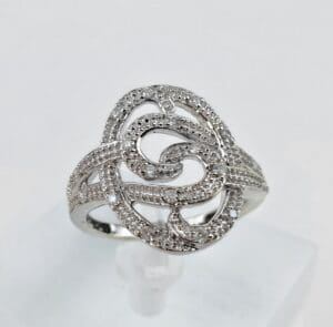 Intricate silver ring with swirling design.