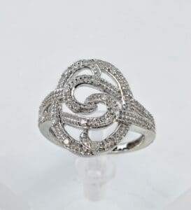 Ornate silver ring with swirling design.