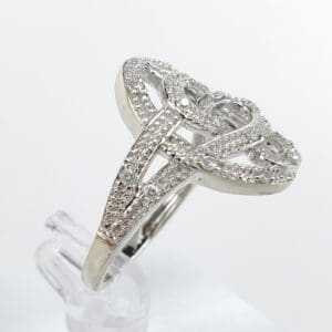 Intricate silver ring with diamond accents.