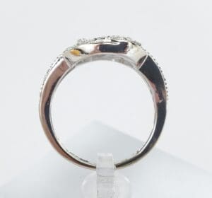 Silver ring on a clear display stand.