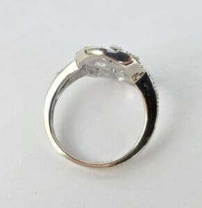 Silver ring with a gemstone side view.