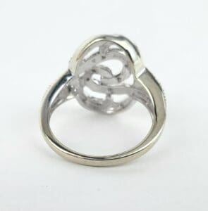 Silver ring with intricate swirl design.