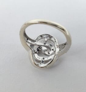 Silver ring with intricate knot design.