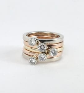 Stacked rings with diamonds in rose gold.