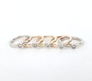 Five rings with diamonds in different metals.
