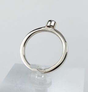 Silver ring on a display stand.