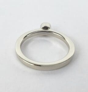 Silver metallic circular keyring on white background.