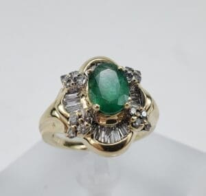 Gold ring with emerald and diamonds.
