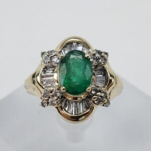 Gold ring with emerald and diamonds.