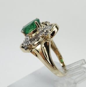 Gold ring with emerald and diamonds.