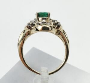 Gold ring with emerald and diamonds.