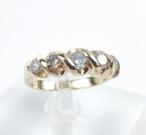 Gold ring with diamond accents displayed elegantly.