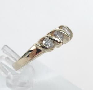 Gold ring with three embedded diamonds.