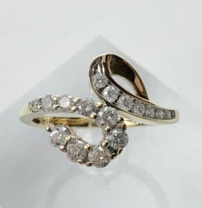 Gold ring with diamond swirl design.