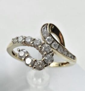 Gold ring with intertwined diamond design.