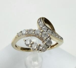 Gold and diamond swirl design ring.
