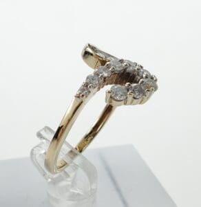 Gold ring with diamond accents on display.