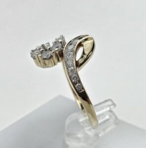 Gold ring with diamonds on display.