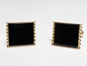 Gold square cufflinks with black enamel.