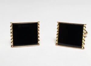 Gold and black square cufflinks.