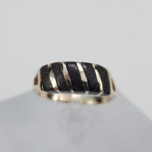 Gold ring with black striped design.