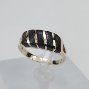 Gold ring with black striped design.