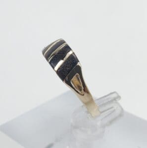 Gold and silver ring on display stand.
