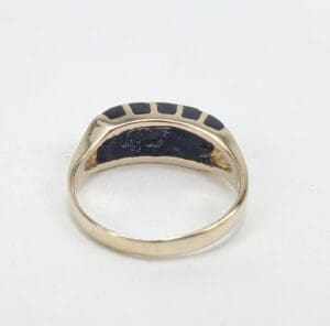 Gold ring with black enamel details.