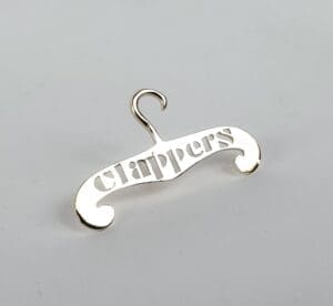 Silver hanger pin with "clappers" text.