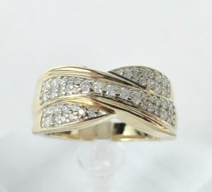 Gold ring with diamond accents, crossover design.
