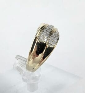 Gold ring with diamond accents on display.
