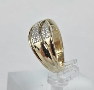 Gold ring with diamond accents on display.