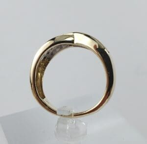 Gold ring on a clear stand.
