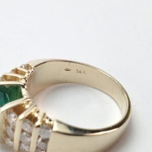 Gold ring with green and white stones.