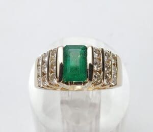 Gold ring with emerald and diamonds.