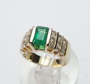 Gold ring with emerald and diamonds.
