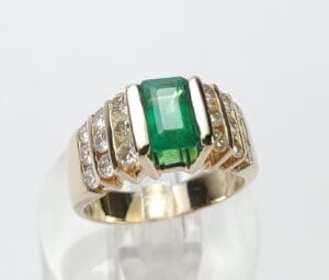 Gold ring with emerald and diamonds.