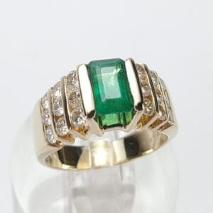 Gold ring with emerald and diamonds.