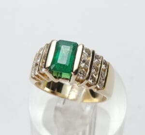 Gold ring with emerald and diamonds.