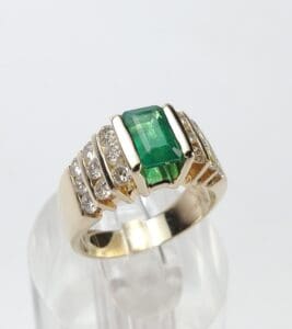 Gold ring with emerald and diamonds.