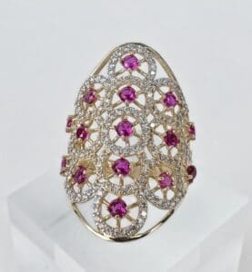 Gold ring with pink and white stones.