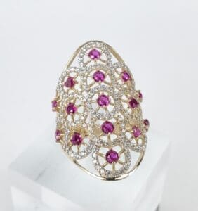 Gold ring with pink gemstones and diamonds.
