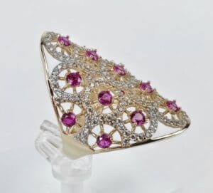 Gold ring with pink and clear gemstones.