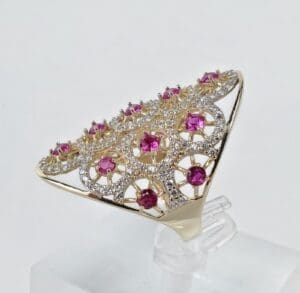 Gold ring with pink and white gems.