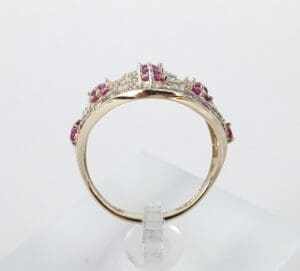 Gold ring with red and white stones.