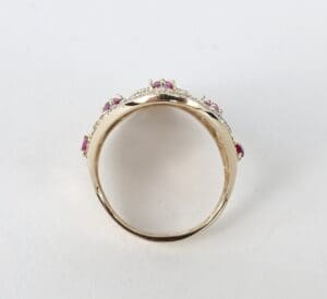Gold ring with pink gemstones and diamonds.