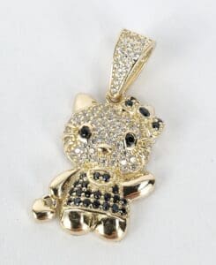 Gold cat pendant with rhinestone details.