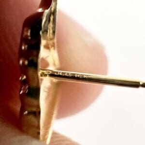 Close-up of a gold earring post.